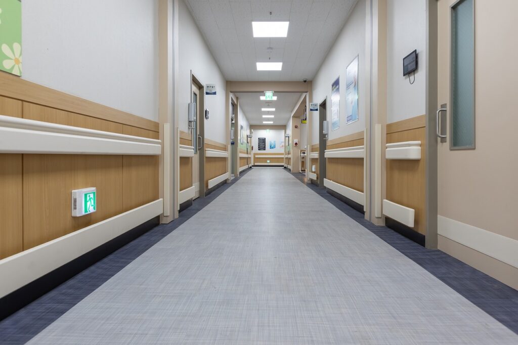 a hallway with a white floor and wood paneled walls